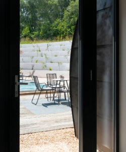 View of the courtyard from the master bedroom at Bigbury Hollow, a Para 80 (PPS 7), energy efficient, passive house. Designed by Hawkes Architecture and featured on Channel 4's Grand Designs.