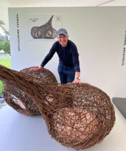 Kevin McCloud with Hawkes Architecture's entry, The dogs, for Goodwoof's, Barkitecture at Goodwood in May 2023.