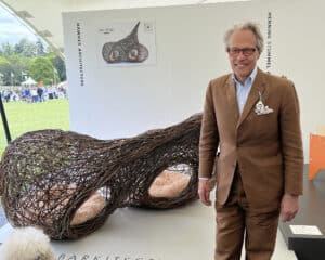 Charles Gordon Lennox, the Duke of Richmond, with Hawkes Architecture's entry, The dogs, for Goodwoof's, Barkitecture at Goodwood in May 2023.