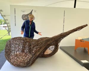 Clare Balding with Hawkes Architecture's entry, The dogs, for Goodwoof's, Barkitecture at Goodwood in May 2023.