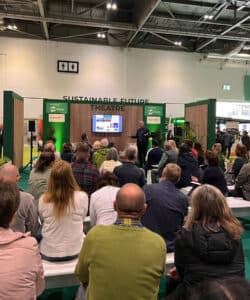 Richard Hawkes of Hawkes Architecture on the stage talking about sustainable living at Grand Designs Live.